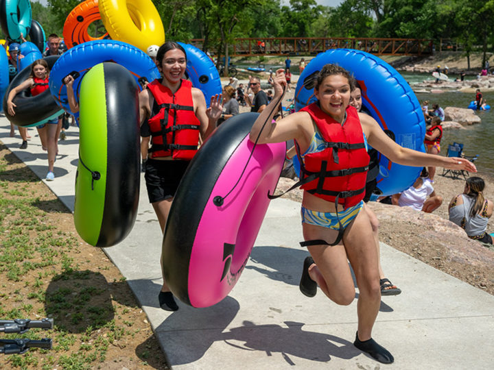 Kids running holding inner tubes