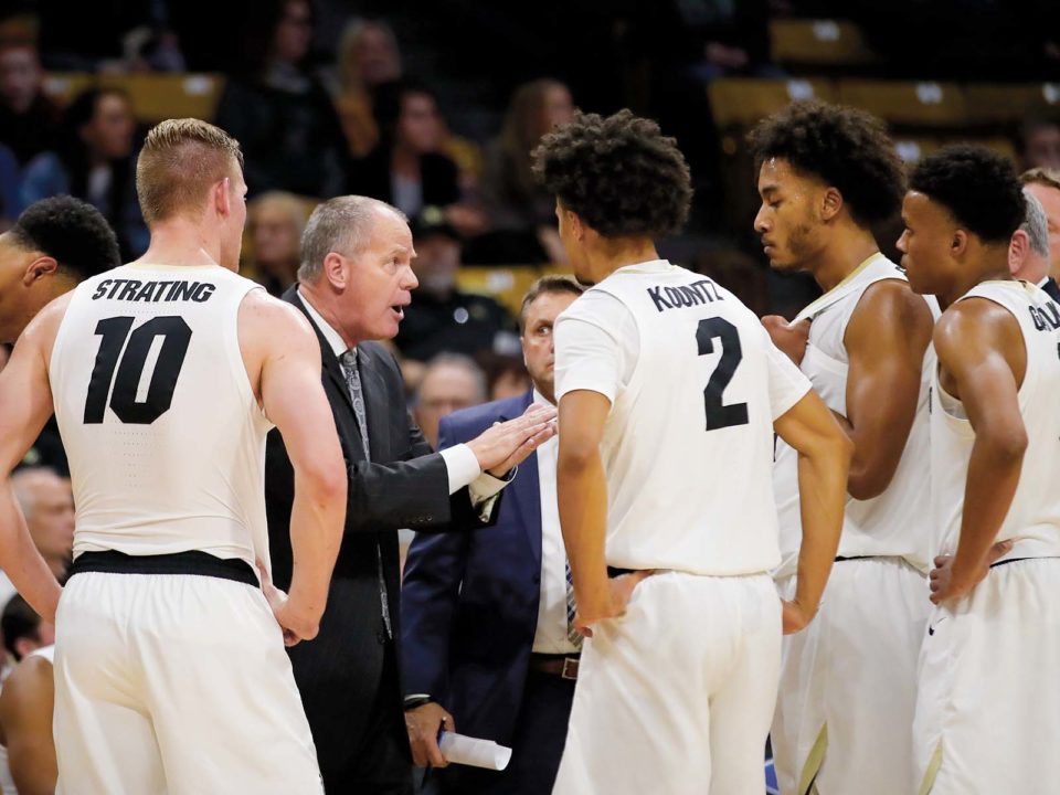 Tad Boyle coaching the CU team in a huddle