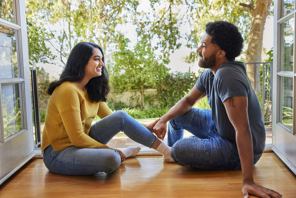 Man and woman sitting and talking in hallway