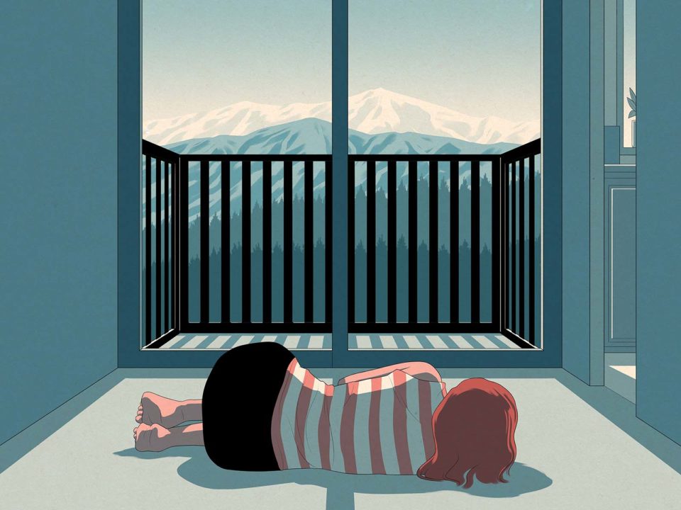 Woman laying on the floor in front of mountain view.