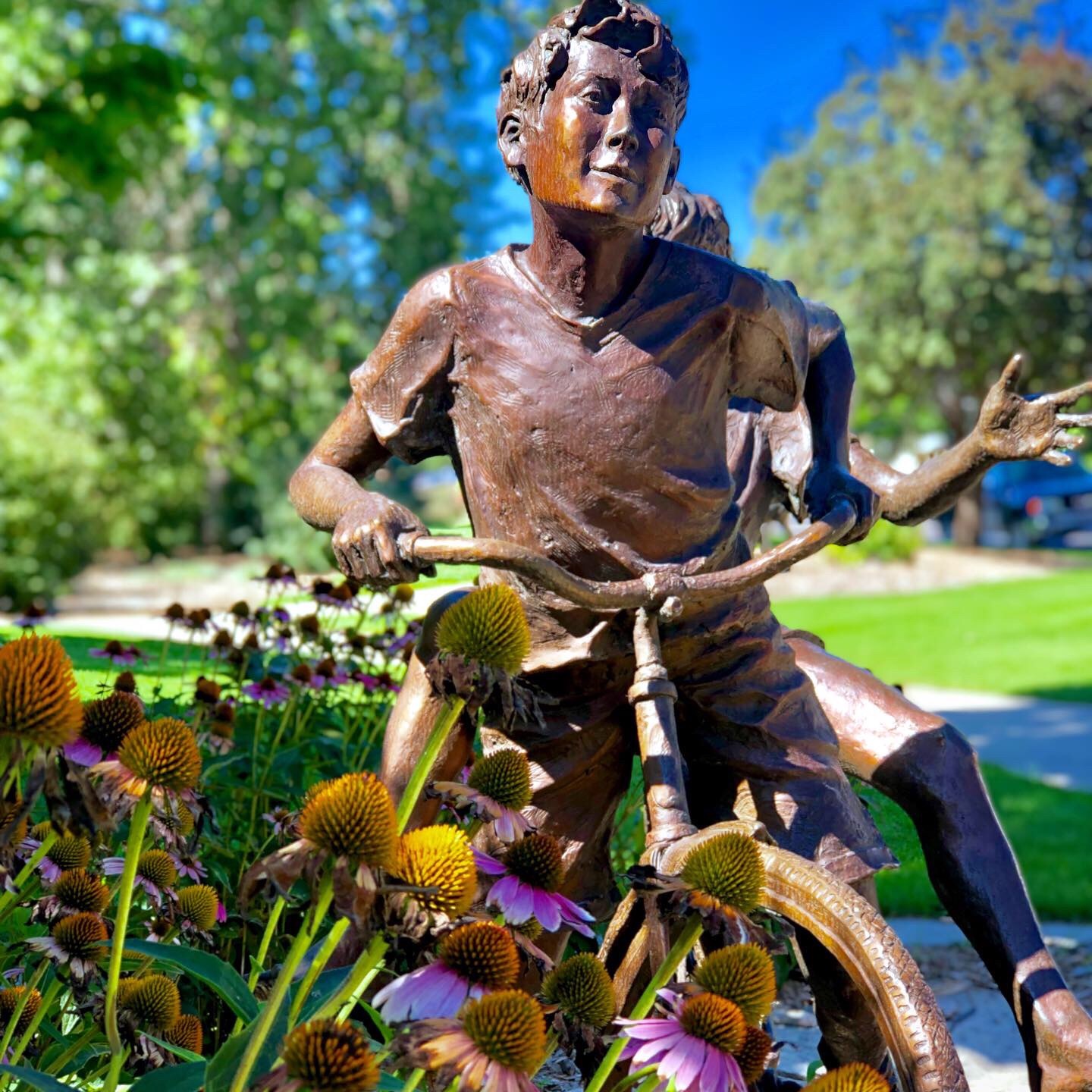 Sculpture of a little boy riding a bike
