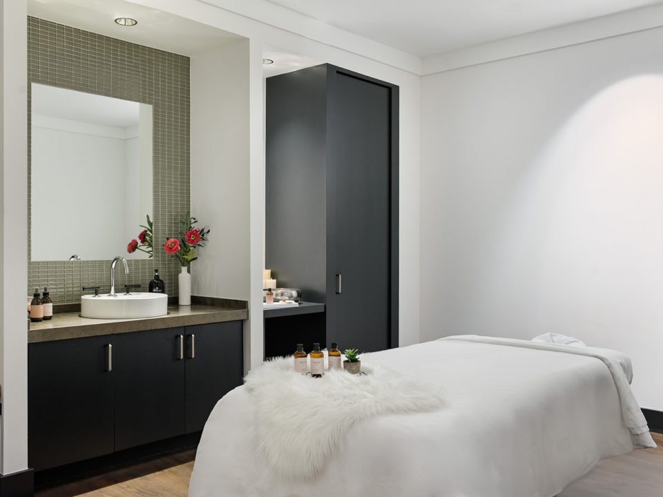 white spa room with a massage table