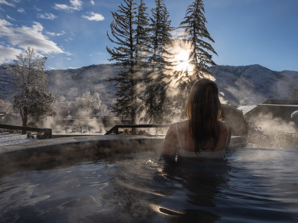 A woman soaks in a geothermal pool
