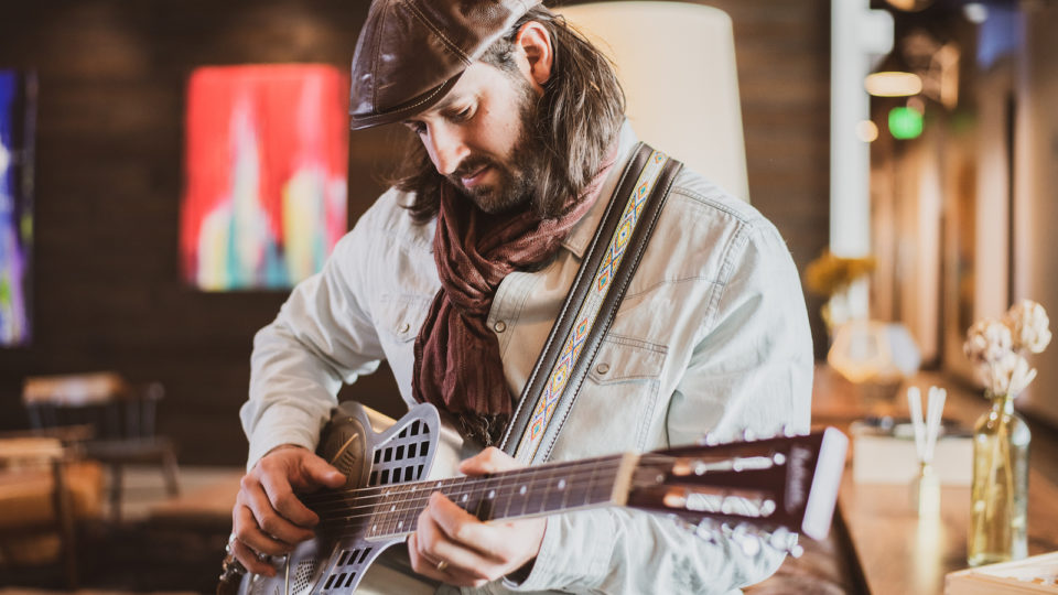 A photo of David Lawrence playing the guitar. Photo by Roxie Photo