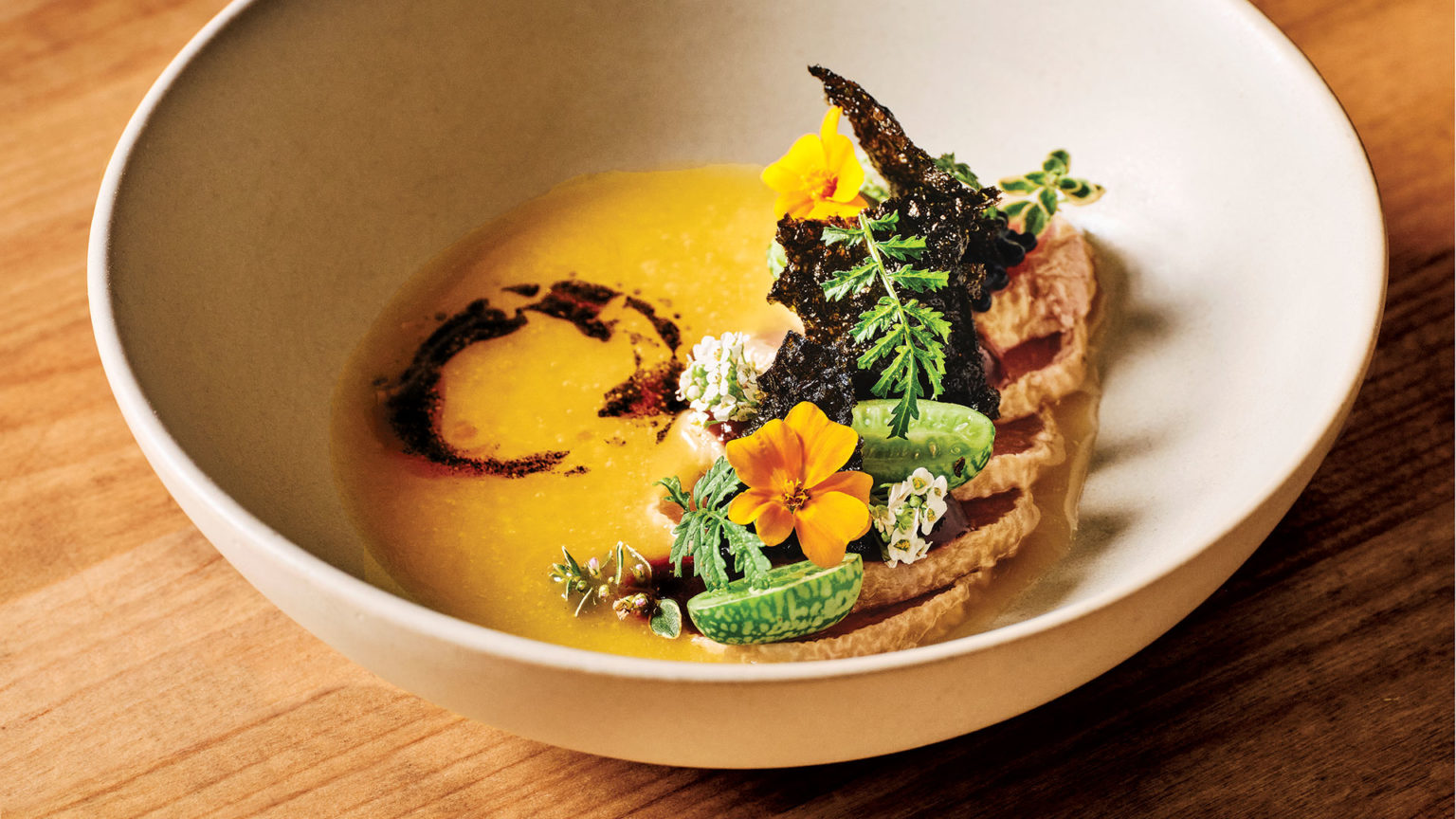 white bowl on wood. orange sauce