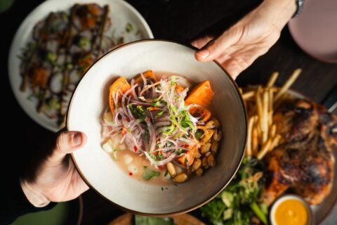 A plate of food and two hands