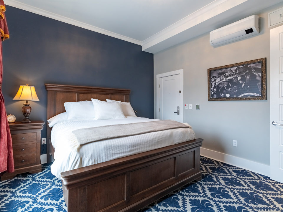 Guest room with a king-size bed, blue-and-white carpet