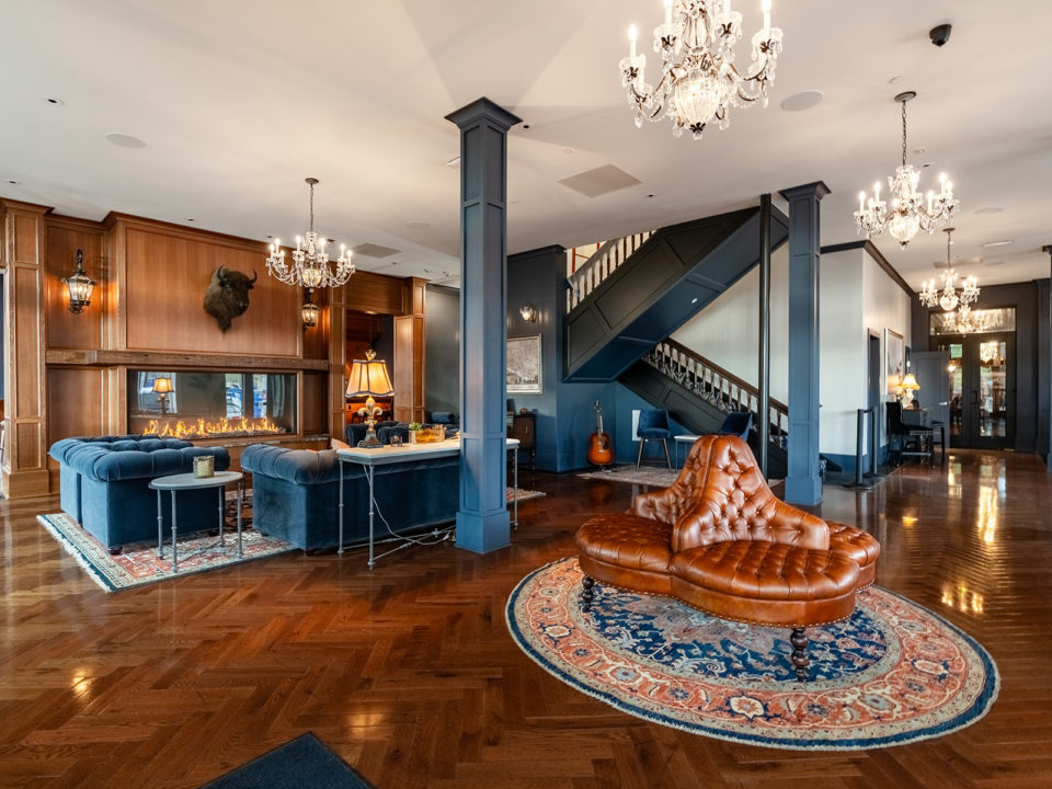 A lobby outfitted Leather couches and warm wood