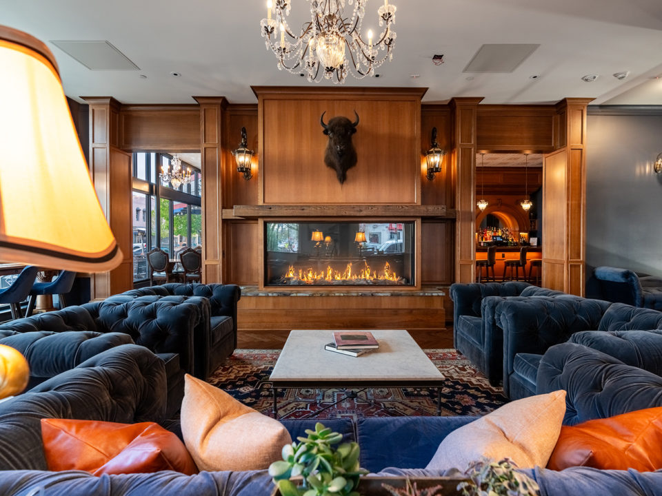 Wood fireplace surrounded by cozy couches