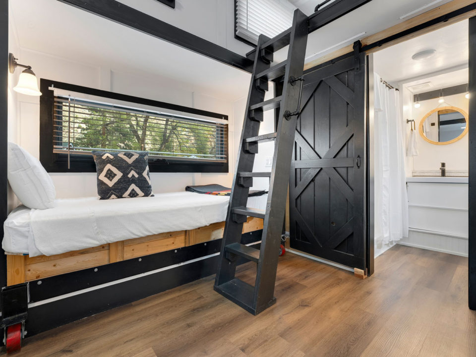 Inside a tiny home with a twin bed