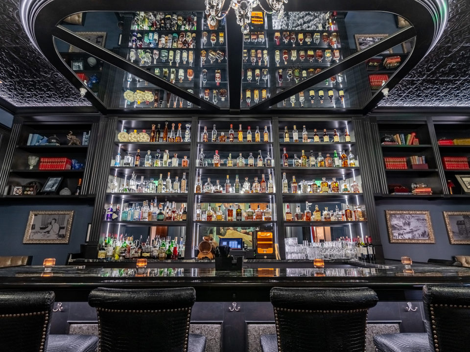 A wall of liquor behind a bar
