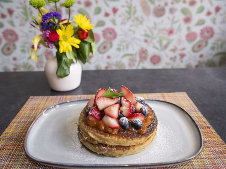 Fruit topped pancakes on a plate at Aspen restaurant Mawa's Kitchen.