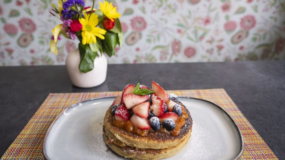Fruit topped pancakes on a plate at Aspen restaurant Mawa's Kitchen.