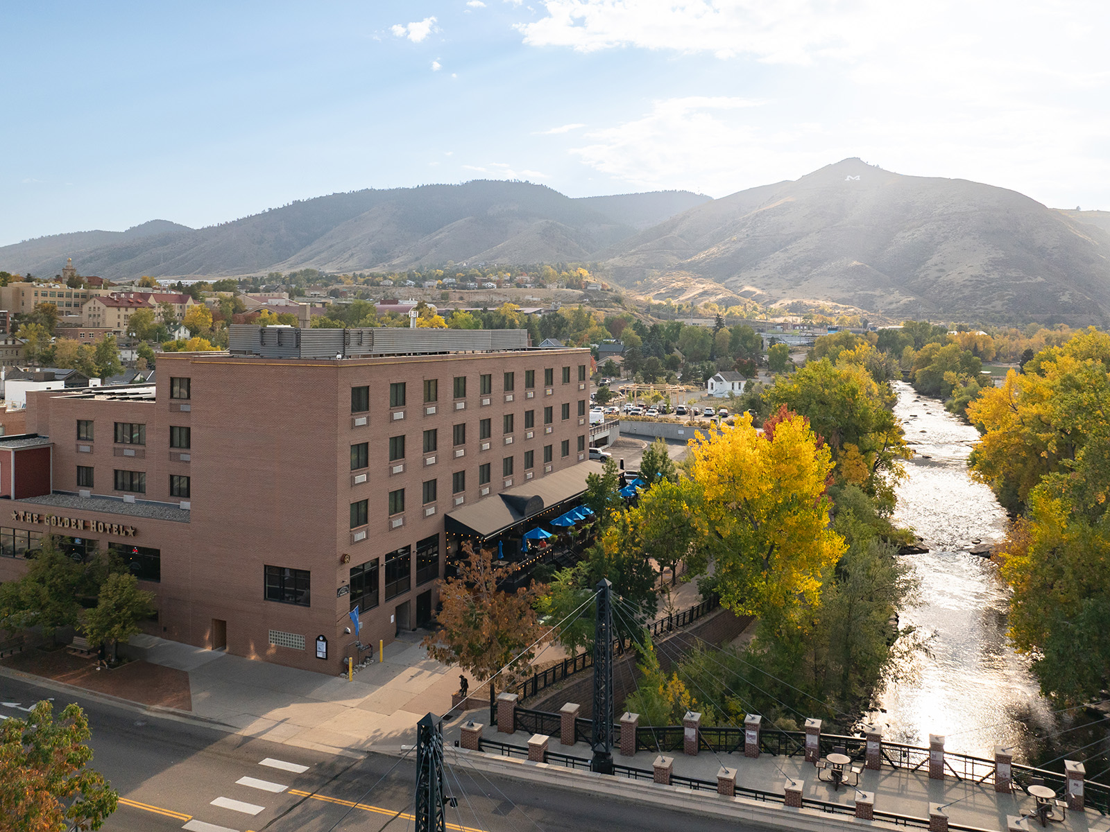 Golden Hotel sits next to Clear Creek with trees changing color