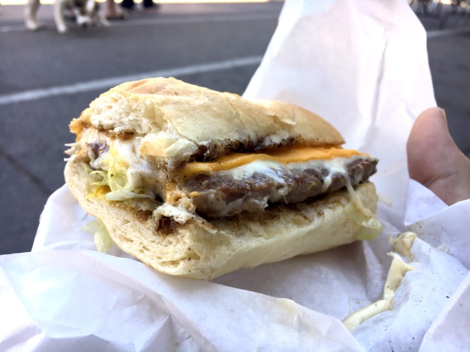 A sausage sandwich on a white wrapper