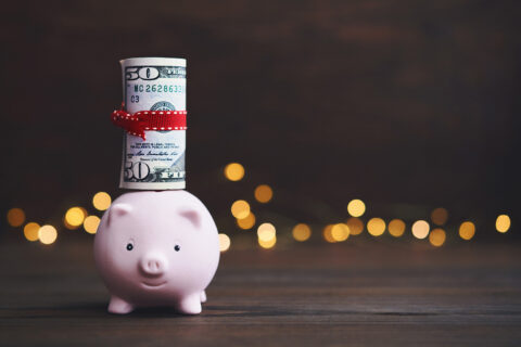 Piggy bank with $50 sticking out