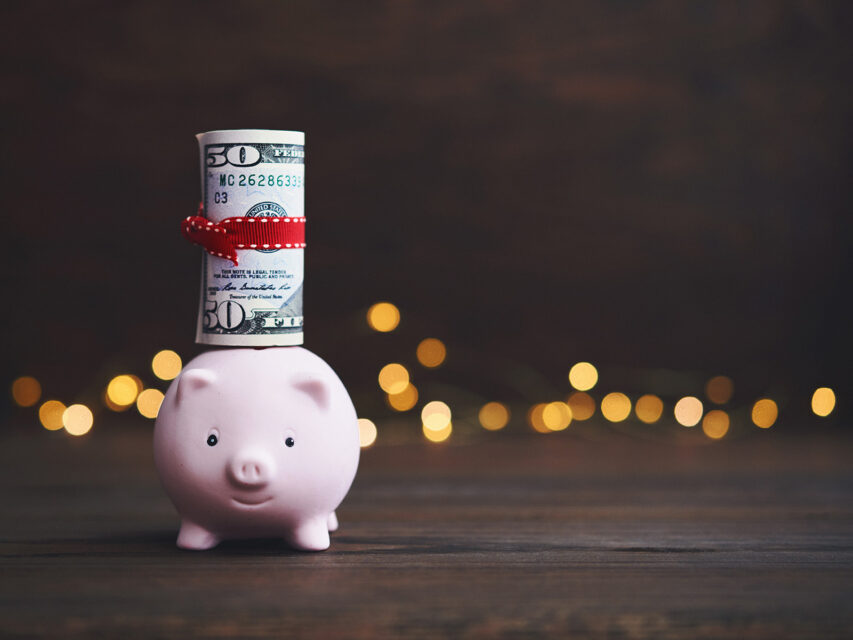 Piggy bank with $50 sticking out