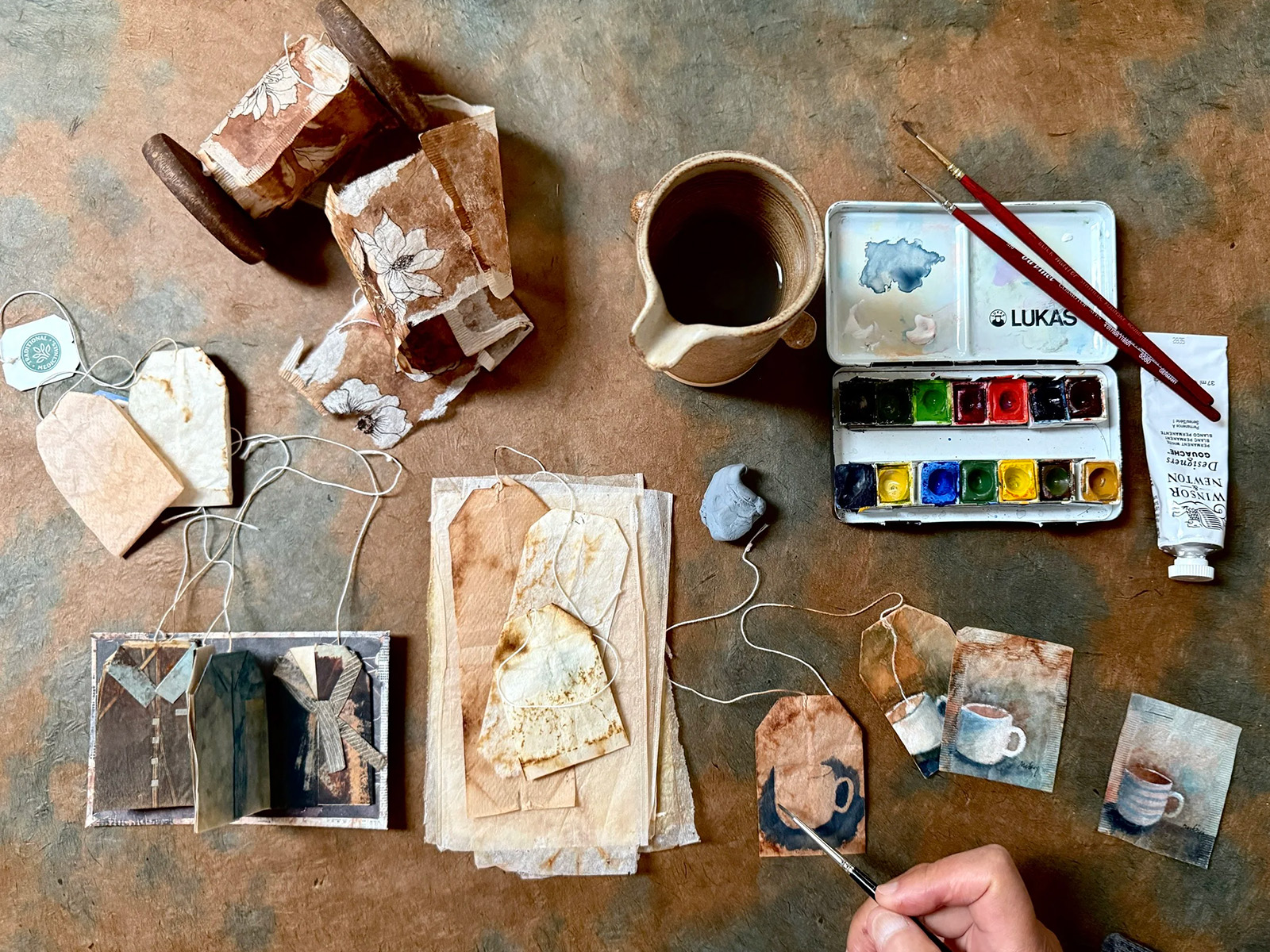 A table of painted tea bags