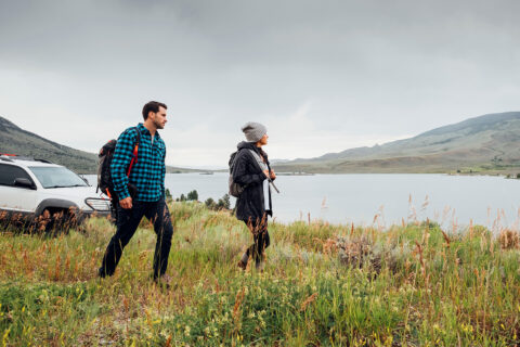 Couple walking in a field by Dillon Reservoir