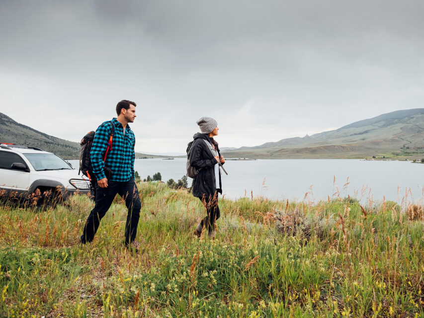Couple walking in a field by Dillon Reservoir