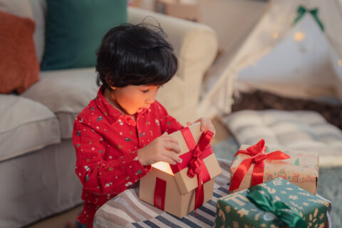 Kid opening a christmas gift