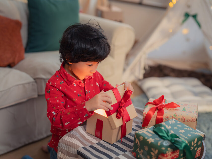 Kid opening a christmas gift