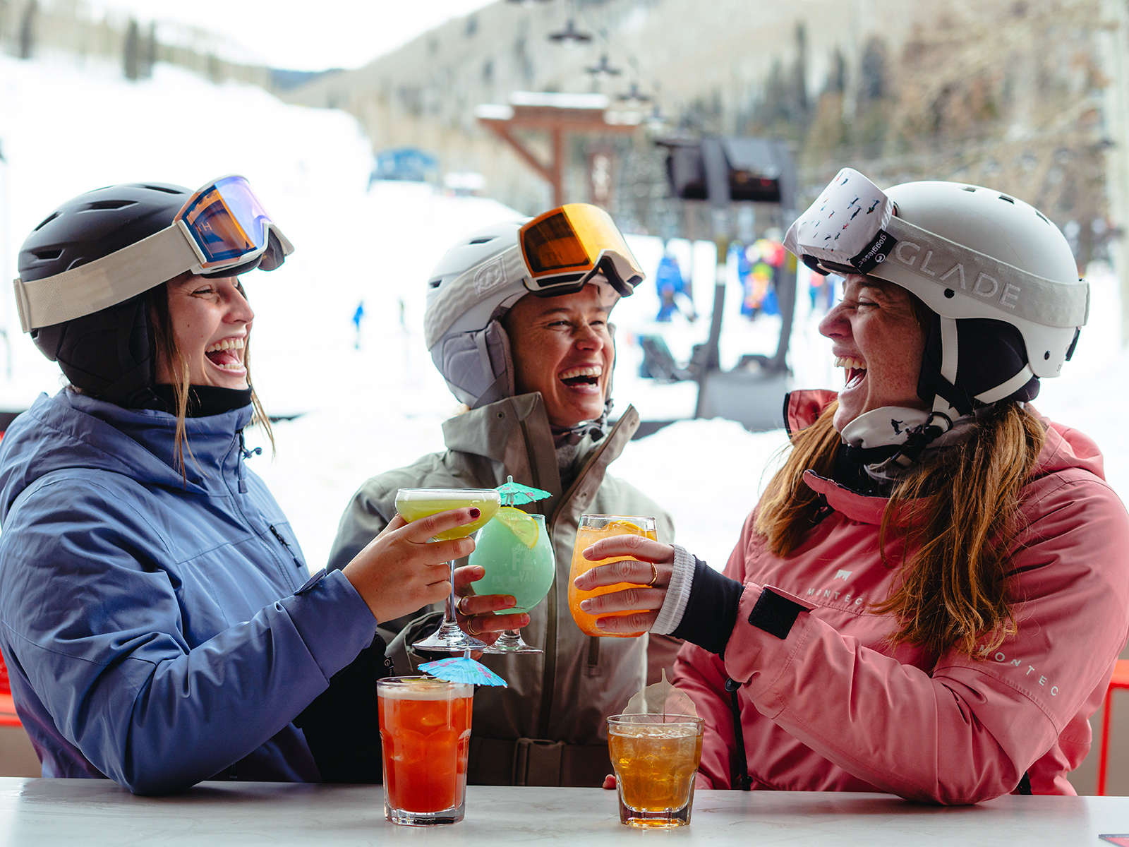 Three skier gals drinking on the Avanti patio at Vail