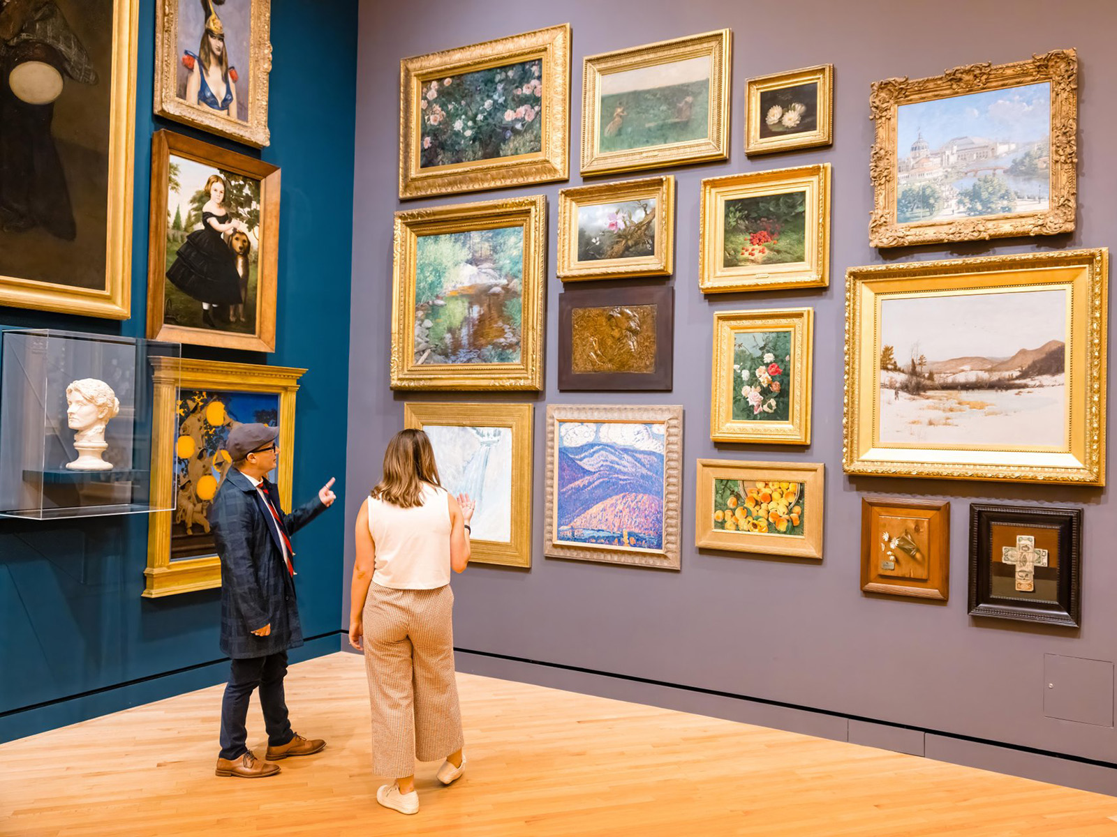 Two people admire art in a museum