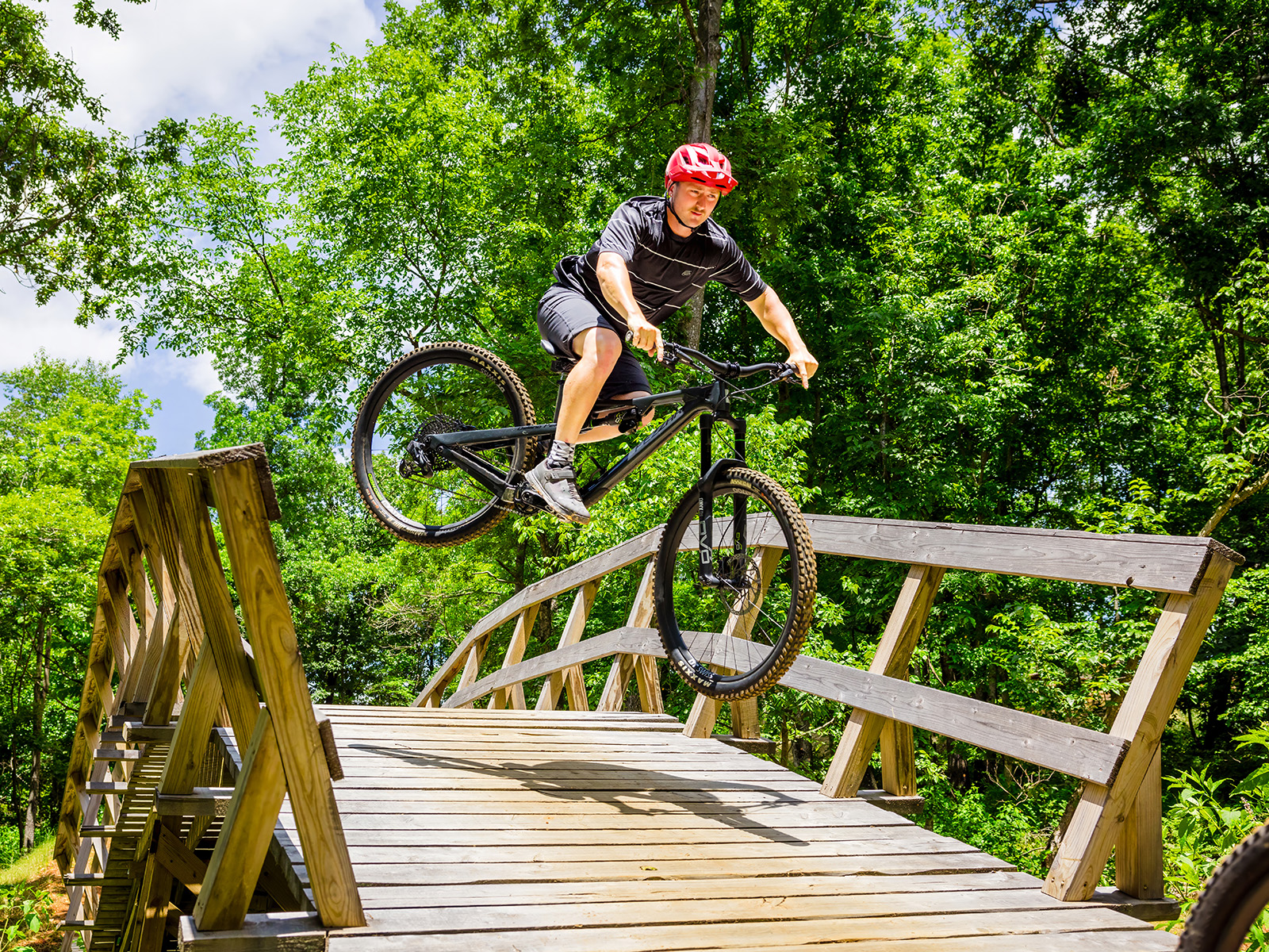 Biker jumping off a trail