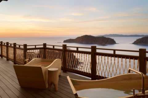 Outdoor tubs on a patio overlooking the ocean
