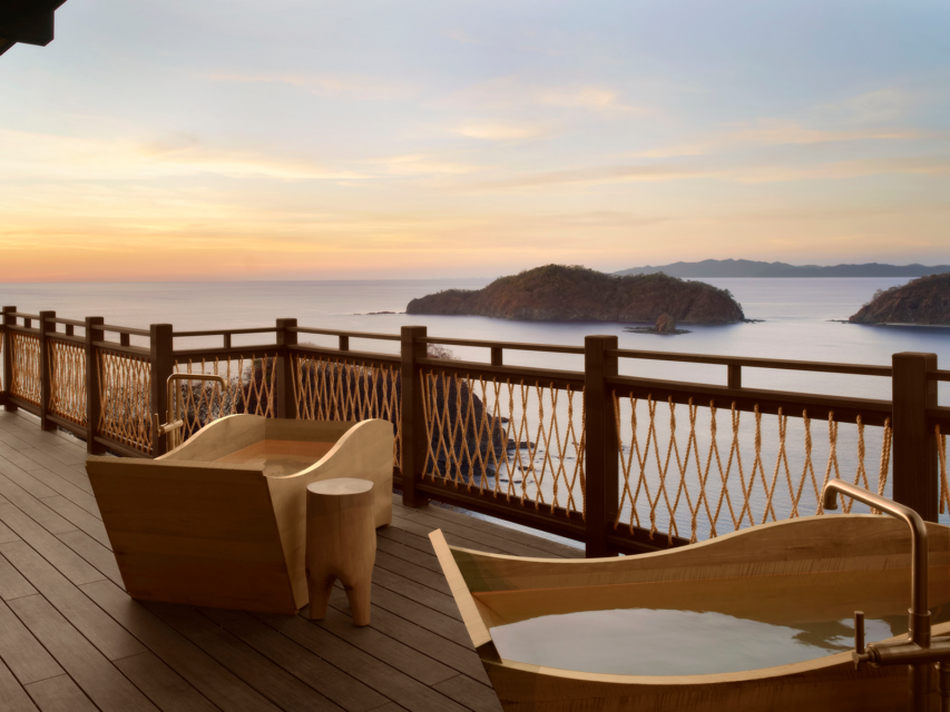 Outdoor tubs on a patio overlooking the ocean