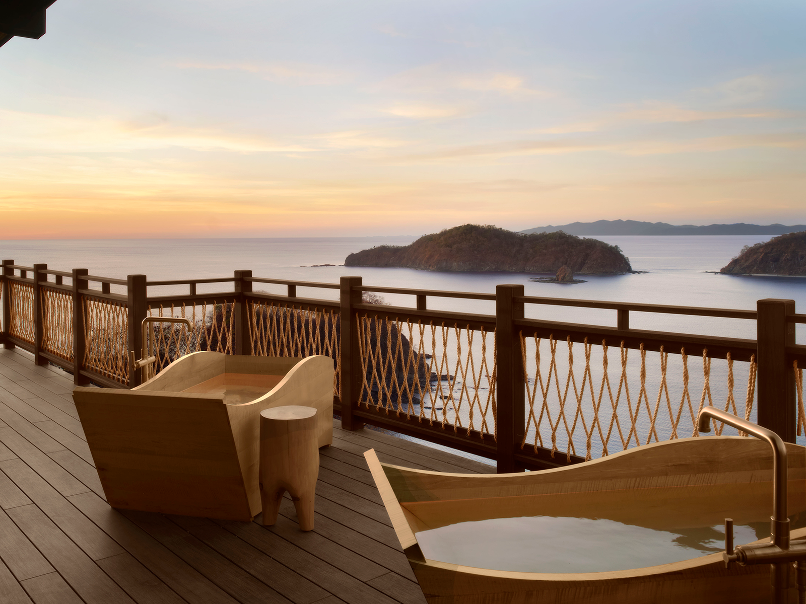 Outdoor tubs on a patio overlooking the ocean