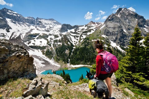 A girl and her pup hiking in the San Juans above Blue Lake