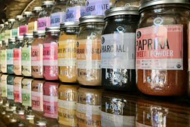 A row of jarred spices at Off the Bottle