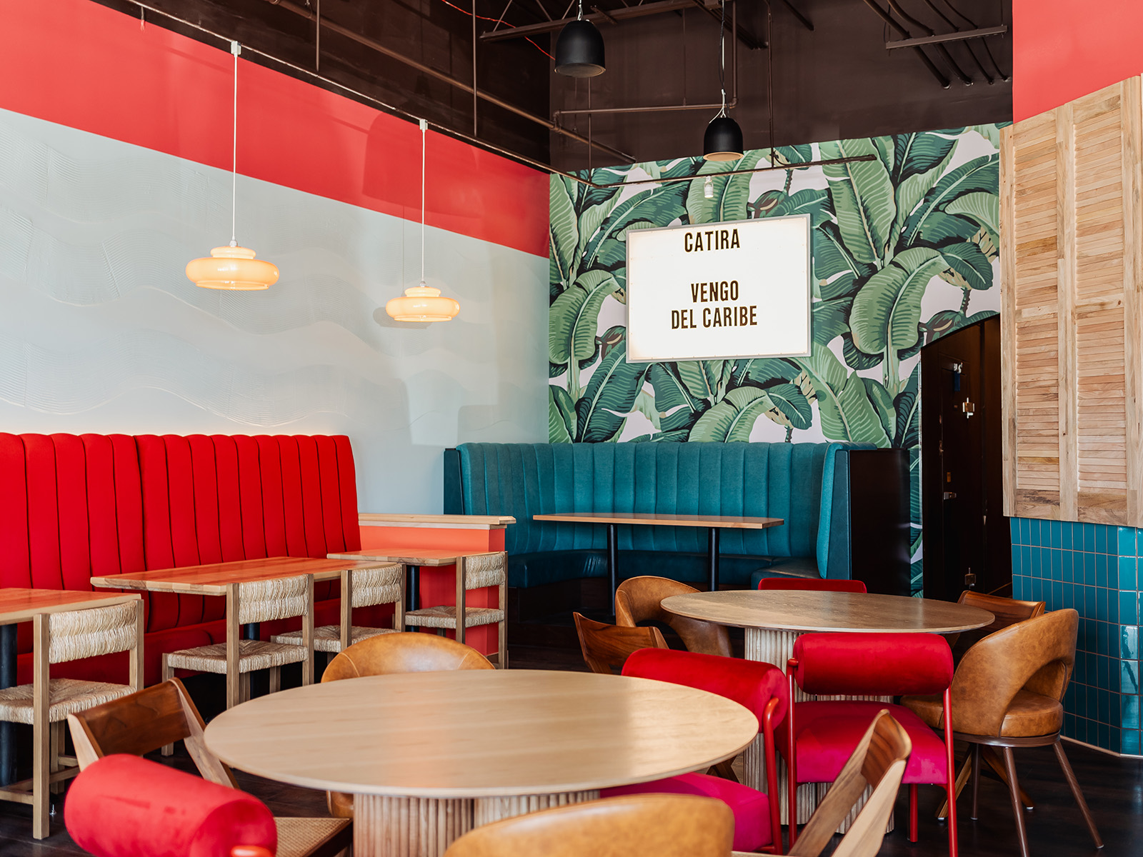 Dining room with floral wallpaper and a lightbox sign