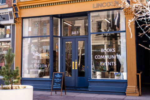A dark blue storefront of a bookstore