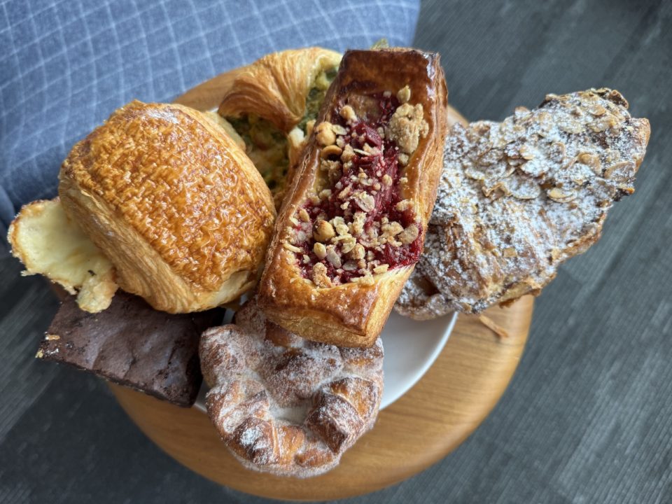 An assortment of pastries overflow a small plate.