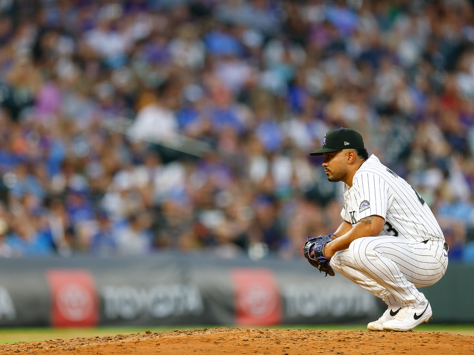 Anthony Molina crouches on the pitchers mound after giving up back-to-back home runs