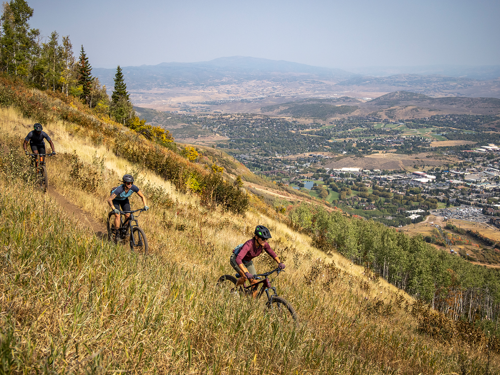 Mountain bikers descend a trail in Park City, Utah