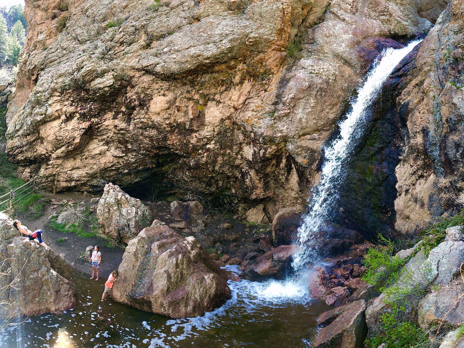 Horsetooth Falls in Fort Collins; three hikers are hanging in the pool below the cascade