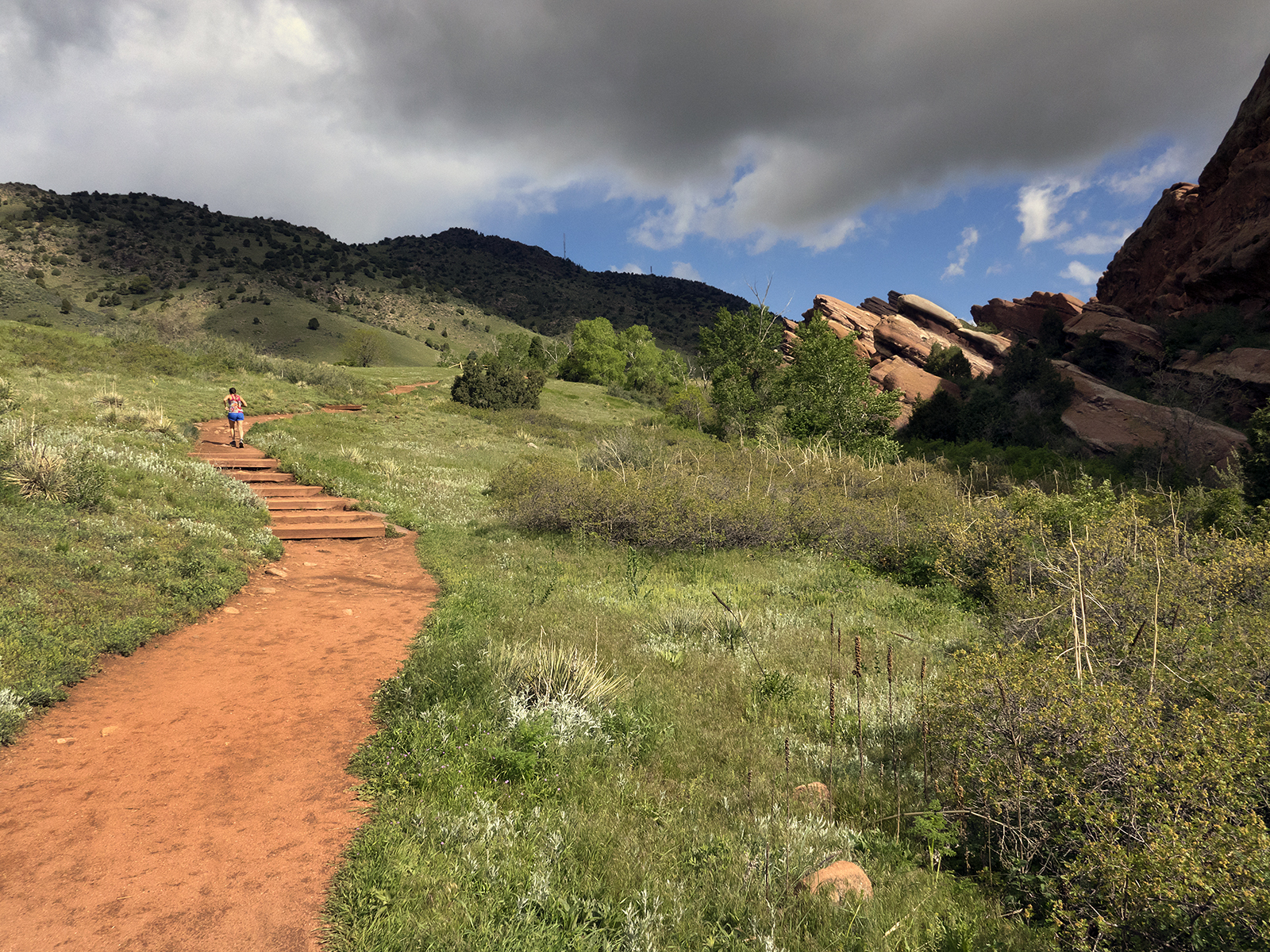 A woman running on the Trading Post Trail at Red Rocks