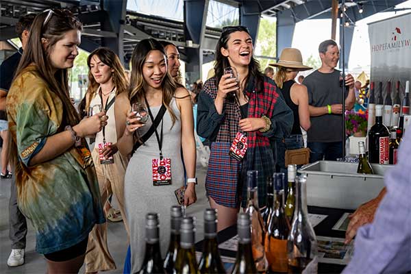 A group of people tasting different wines