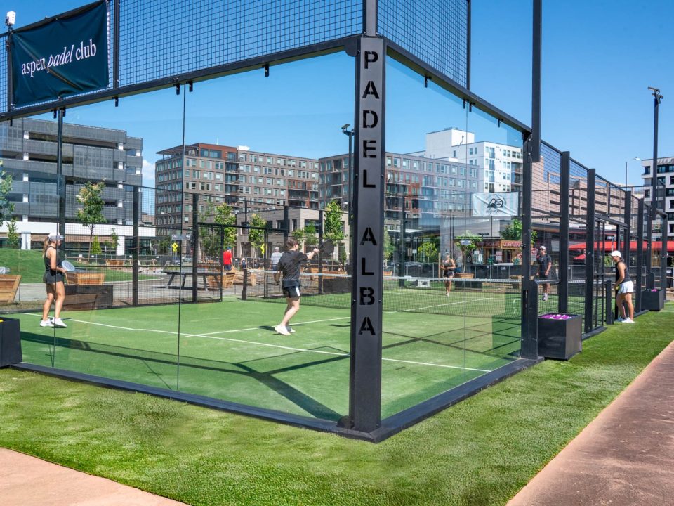 Players with raquets on a padel court