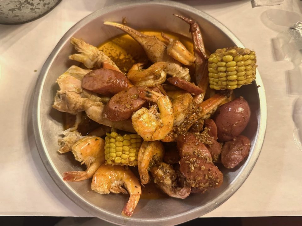 A seafood boil of shrimp, sausage, corn, and snow crab