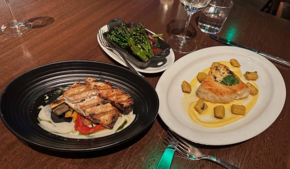 A plate of wild Mexican white sea bass and wild Ross Sea Chilean sea bass with grilled broccolini and Chinese sausage