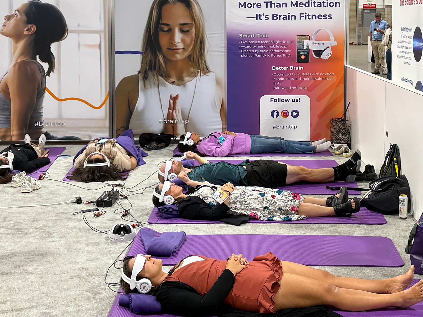 People laying on their backs with eye masks and headphones on.