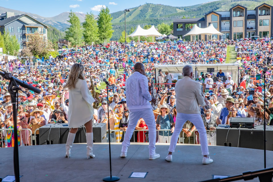 An on-stage view of performers playing for a crowd