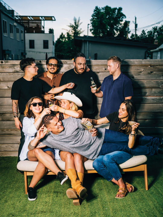 Johnny Curiel lies across his friends at a pig roast