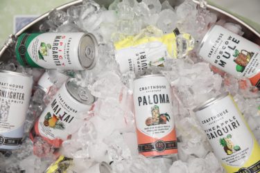 Cans of Crafthouse paloma cocktails and other brands in a metal tub of ice