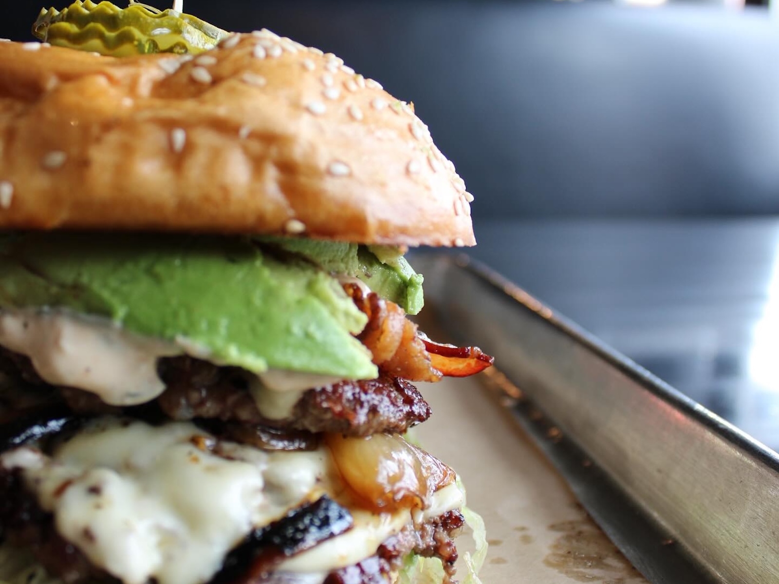 Close-up of a smashburger with a seeded bun
